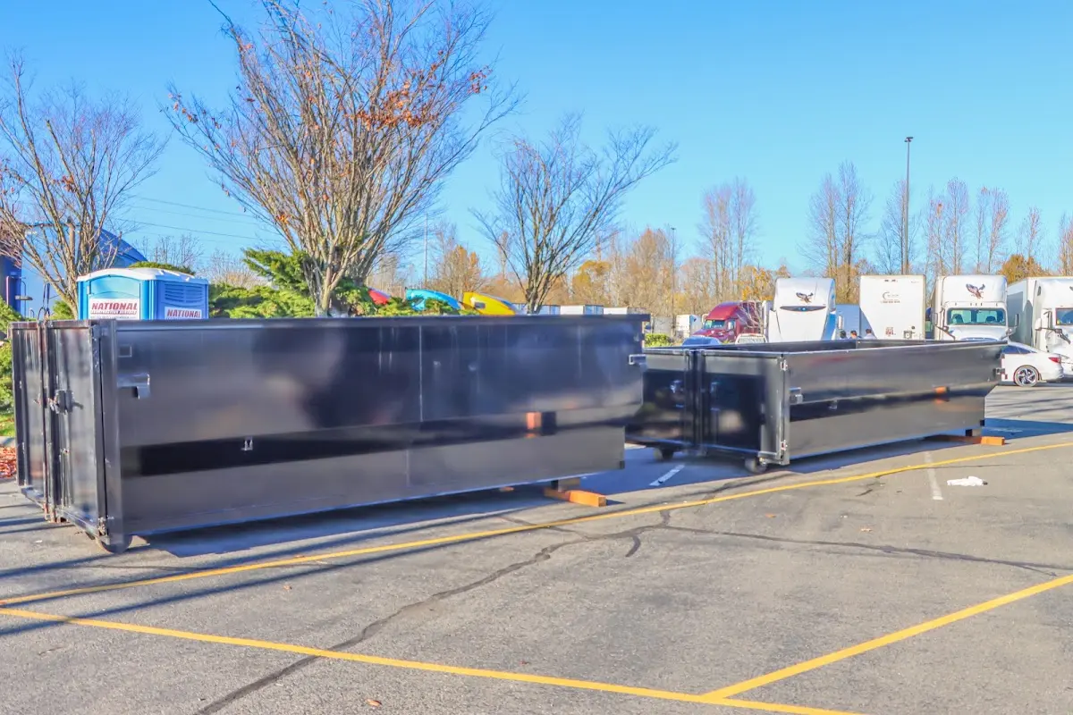 Professional dumpster rental service with roll-off container on residential driveway in Stamford